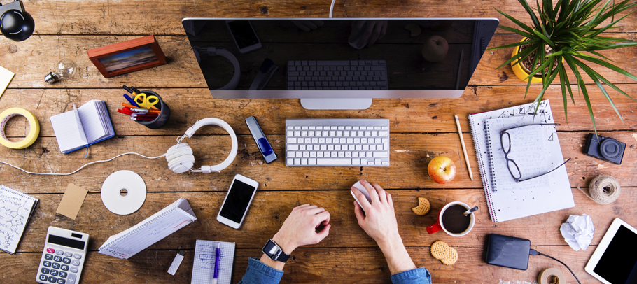 Business person working at office desk wearing smart watch